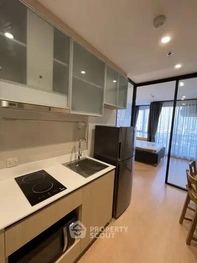 Modern kitchen with sleek appliances and open layout in stylish apartment