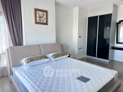 Modern bedroom with stylish decor and ample natural light