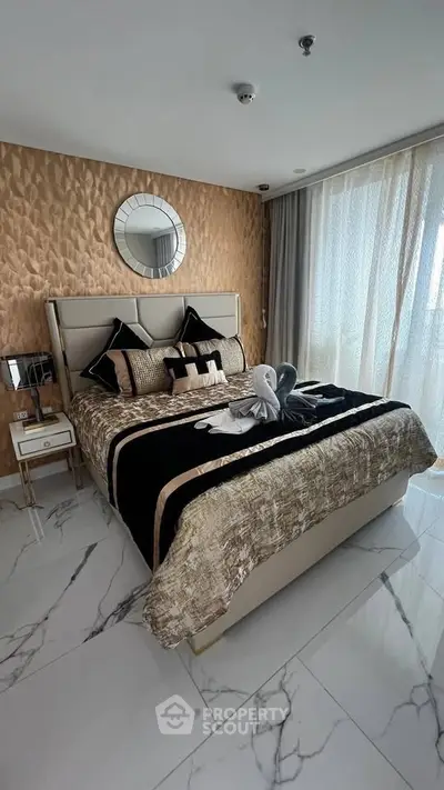 Luxurious bedroom with elegant decor and marble flooring in a modern apartment.