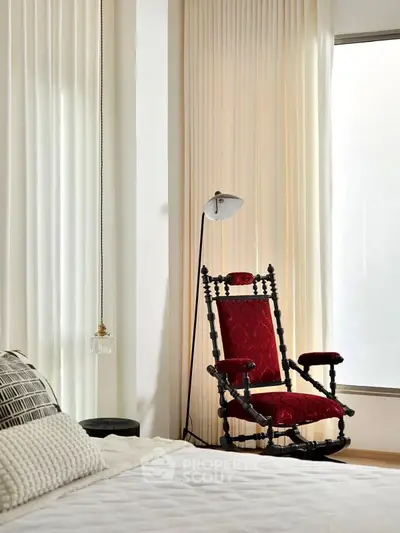 Elegant bedroom with vintage red chair and modern decor