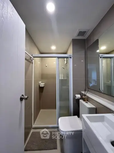 Modern bathroom with sleek shower and contemporary fixtures.
