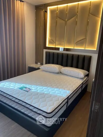 Modern bedroom with stylish lighting and comfortable bed in a contemporary apartment.