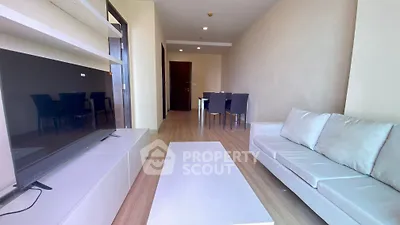 Spacious modern living room with sleek furniture and dining area, perfect for urban living.