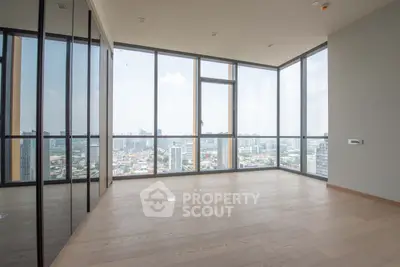 Spacious corner unit with floor-to-ceiling windows offering panoramic city views and abundant natural light.