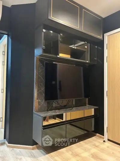 Modern living room with sleek black entertainment unit and mounted TV