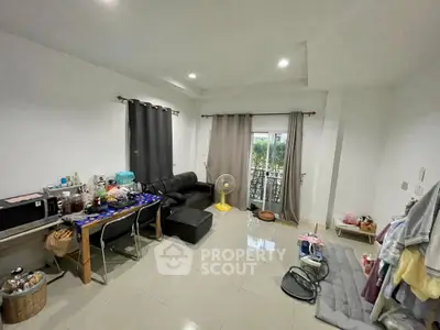 Spacious living room with modern furnishings and natural light, perfect for relaxation and entertainment.