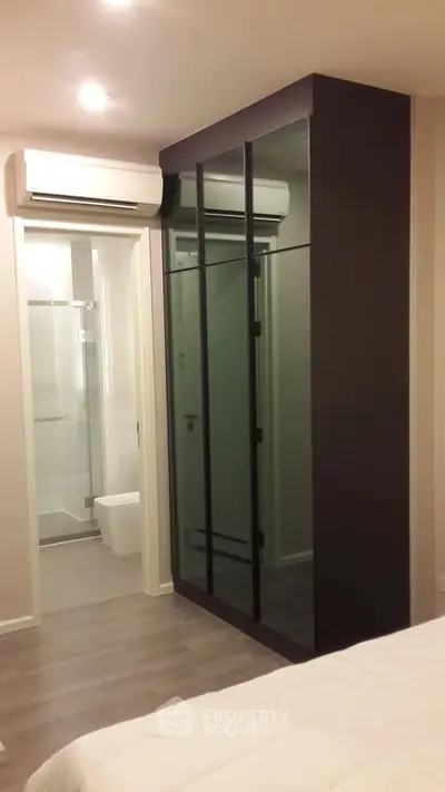 Modern bedroom with sleek wardrobe and ensuite bathroom