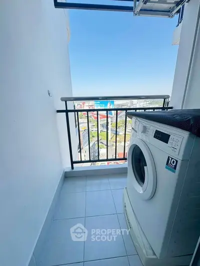 High-rise balcony with washing machine and city view