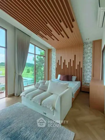 Luxurious bedroom with modern design, large windows, and scenic view, featuring stylish wood paneling and cozy seating.