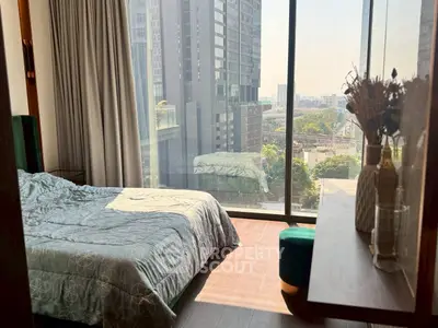 Modern bedroom with floor-to-ceiling windows and city view