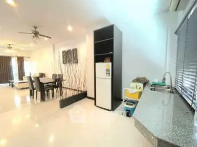 Spacious modern living room with dining area and sleek kitchen design