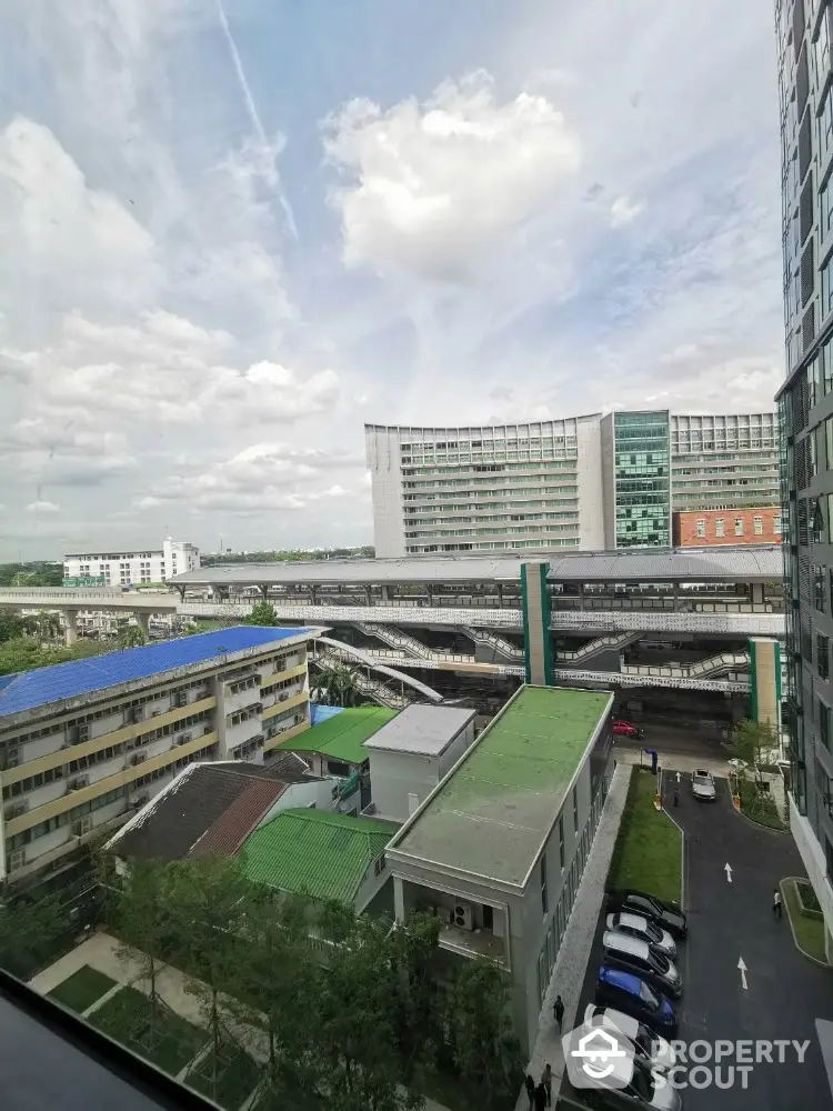 Stunning urban view from high-rise building overlooking modern cityscape and transportation hub.