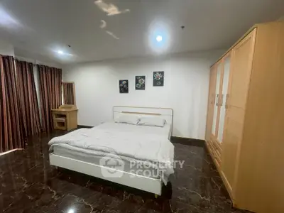 Spacious bedroom with modern furnishings and elegant decor