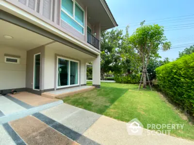 Modern two-story house with lush garden and spacious lawn