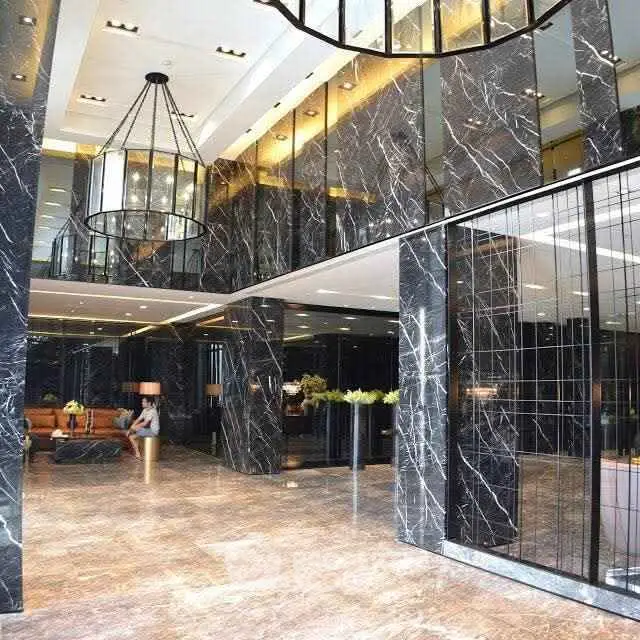 Luxurious building lobby with elegant marble finishes and modern lighting.