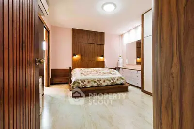 Elegant bedroom with wooden accents and modern lighting