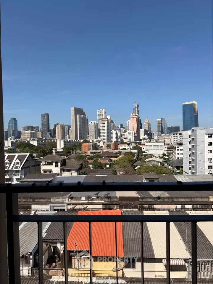 Stunning cityscape view from a high-rise balcony in urban setting.