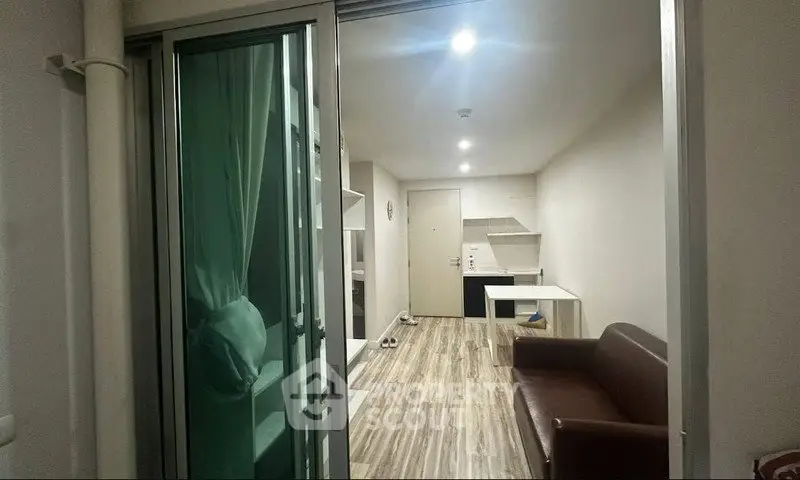 Modern apartment interior with sliding glass doors and cozy living area.