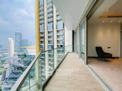 Luxurious high-rise balcony with stunning cityscape view and modern interior access.