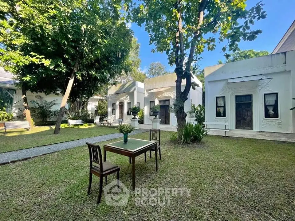 Charming garden courtyard with lush greenery and classic architecture