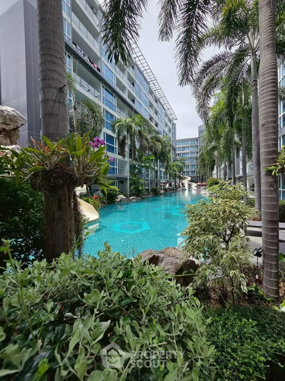 Luxurious condominium with stunning pool and lush greenery