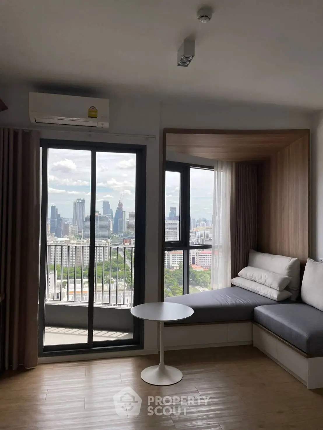 Modern living room with city view and cozy seating area