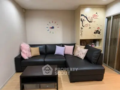 Cozy living room with stylish black sectional sofa and modern decor