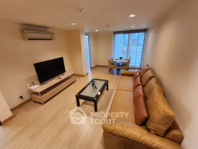 Spacious living room with modern decor and dining area, perfect for entertaining guests.