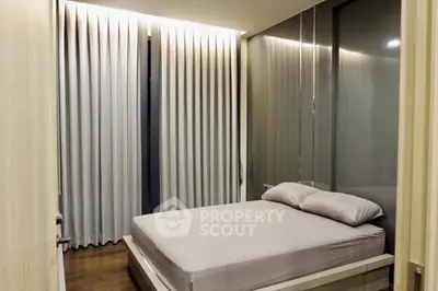 Modern bedroom with sleek design and floor-to-ceiling curtains