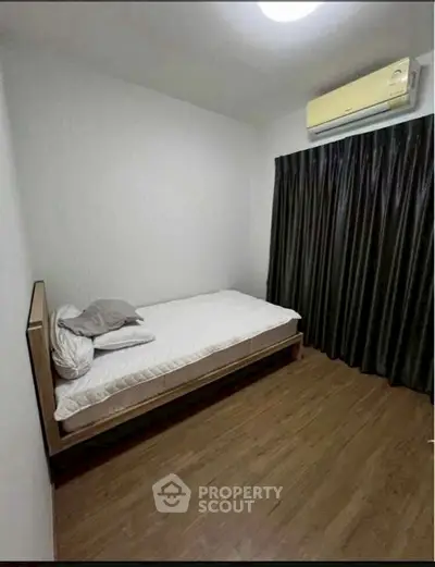 Cozy minimalist bedroom with single bed and air conditioning