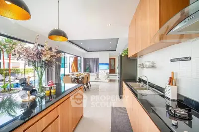 Luxurious open-layout kitchen with modern appliances and elegant dining area, perfect for entertaining.