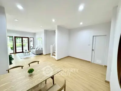 Spacious open-plan living and dining area with modern decor and natural light.