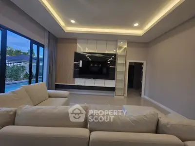 Luxurious living room with modern design, large windows, and elegant lighting, perfect for relaxation and entertainment.