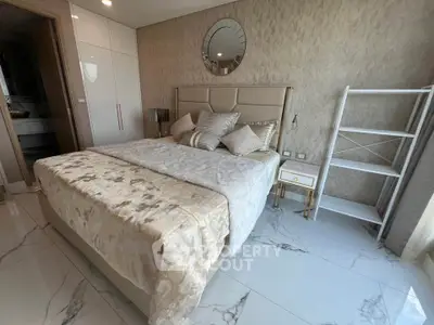 Luxurious bedroom with elegant decor and marble flooring in modern apartment.