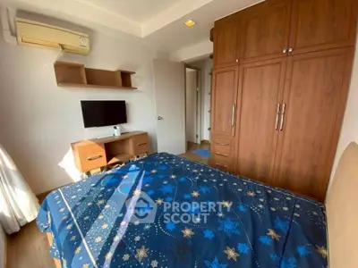 Cozy bedroom with wooden furniture and air conditioning, perfect for relaxation.