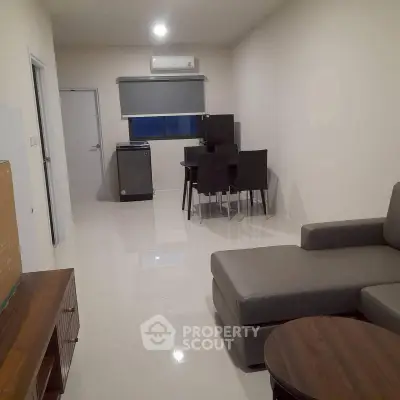Modern living room with sleek furniture and dining area in open layout