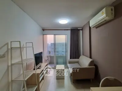 Modern living room with balcony view, featuring sleek furniture and natural light.