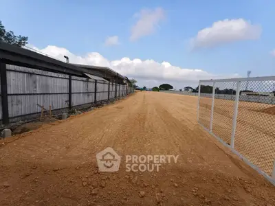 Expansive construction-ready land plot with clear skies and potential for development.