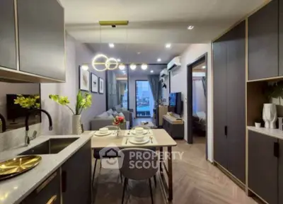 Modern open-layout kitchen and living room with stylish decor and elegant lighting