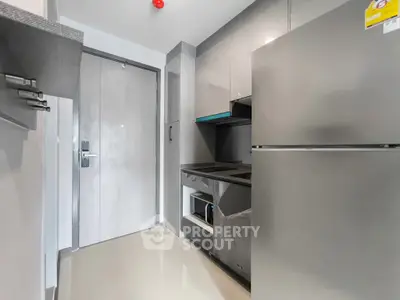 Modern compact kitchen with sleek appliances and minimalist design
