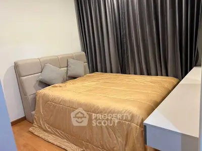 Cozy bedroom with modern decor and elegant curtains, perfect for relaxation.