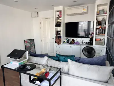 Modern living room with wall-mounted TV and stylish decor