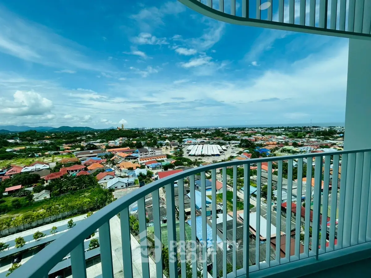 Stunning panoramic view from a modern balcony overlooking a vibrant cityscape.