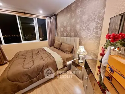 Luxurious bedroom with elegant decor and city view, featuring plush bedding and stylish furnishings.