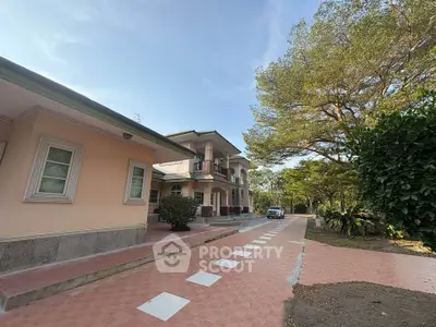 Charming suburban home with spacious driveway and lush greenery, perfect for family living.