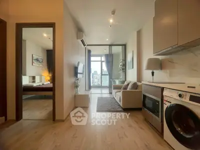 Modern apartment interior with open layout, featuring a cozy living room and a view of the city skyline.