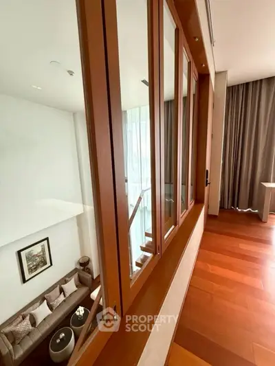 Luxurious duplex living room with wooden floors and elegant decor