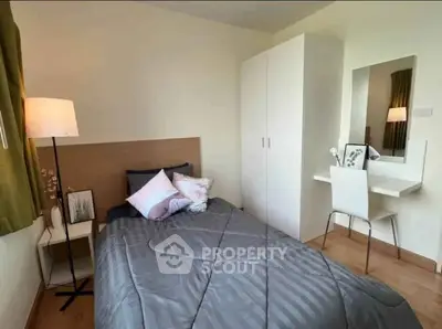 Cozy bedroom with modern decor, featuring a comfortable bed, stylish wardrobe, and elegant vanity area.