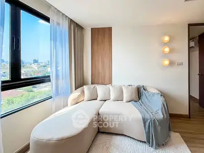 Bright and cozy living room with modern sofa and city view window