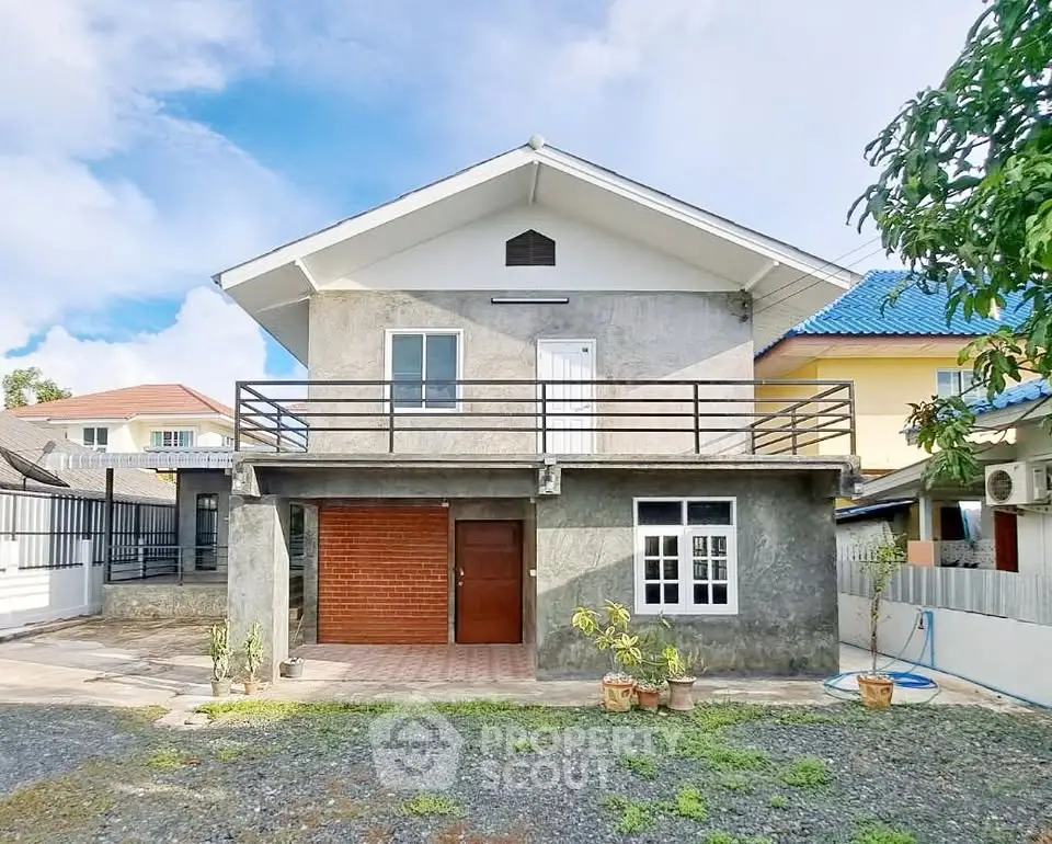 Charming two-story house with balcony and spacious front yard